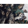 Iceberg Towers Over Greenland Village